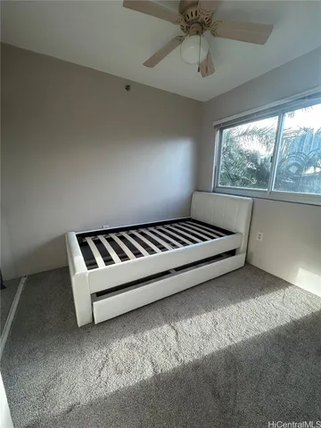 a spacious bedroom with a bed and a window