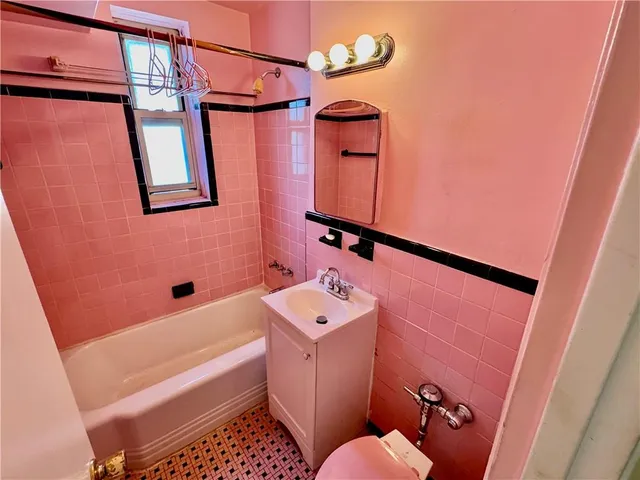 a view of a room with wooden floor and window