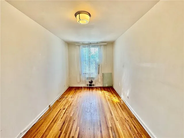 a view of a room with wooden floor