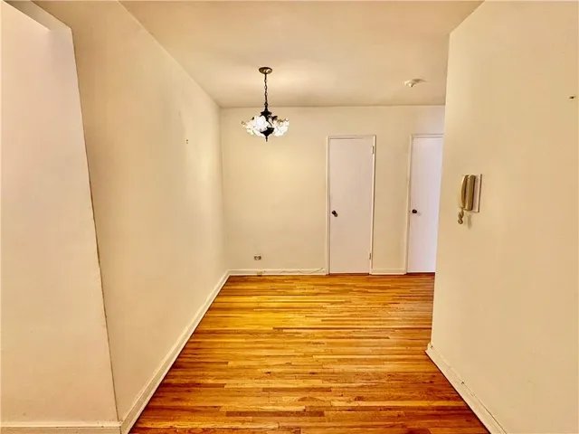a very nice looking room with a chandelier fan and wooden floor