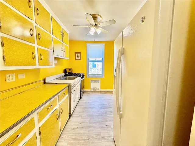 a kitchen with wooden cabinets and a stove top oven