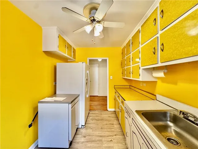 a kitchen with a refrigerator and a sink