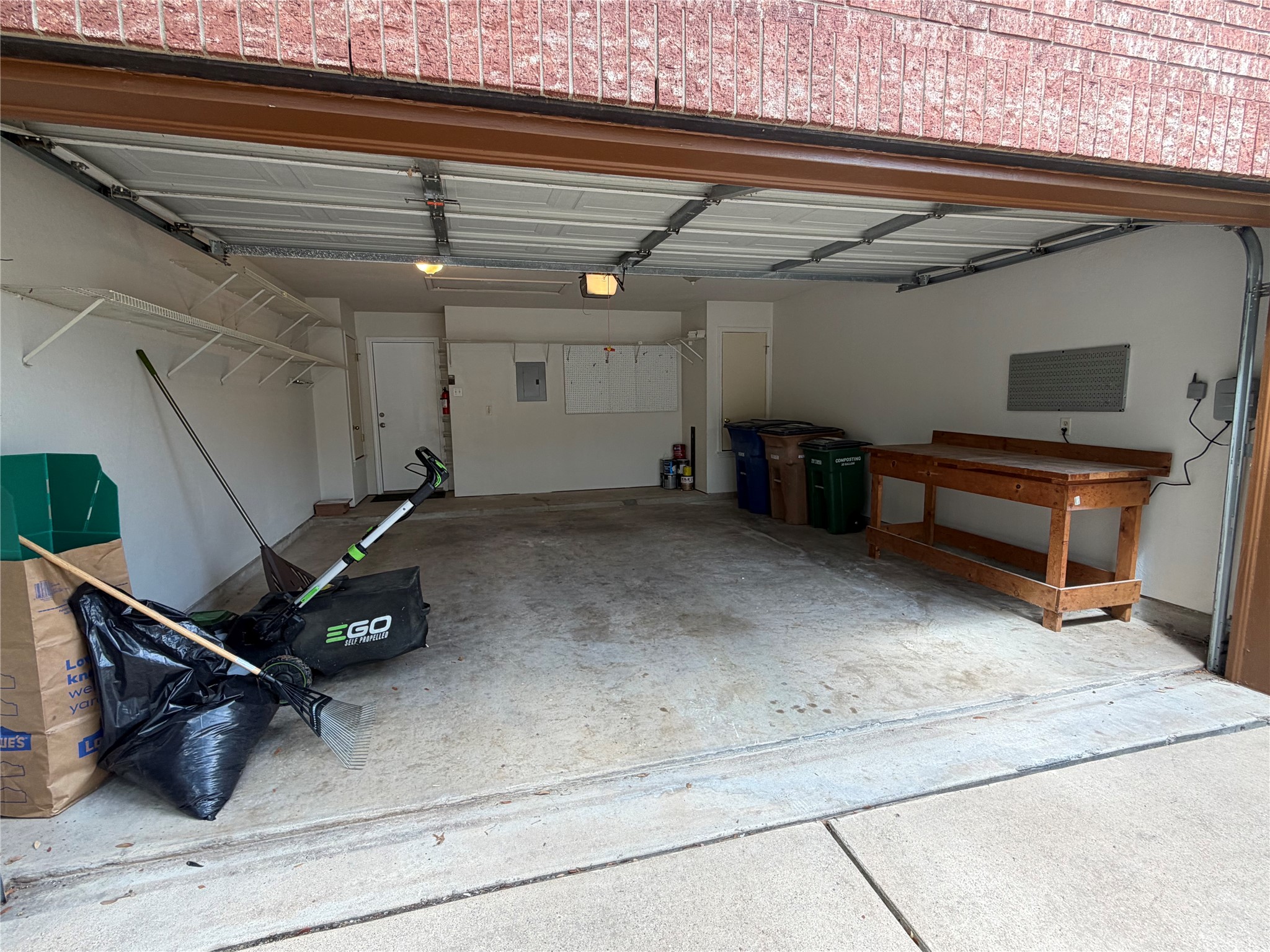 4604 Ramies Run Austin, TX 78749 - Photo 34 of 38 A spacious garage features concrete flooring, built-in shelving, and a sturdy wooden workbench.
