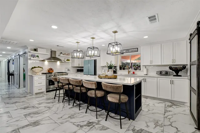 a large kitchen with a table and chairs