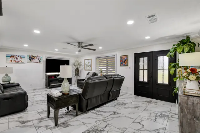 a living room with furniture window and wooden floor
