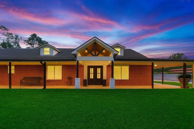 a front view of a house with a big yard