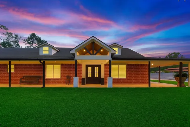 a front view of a house with a big yard