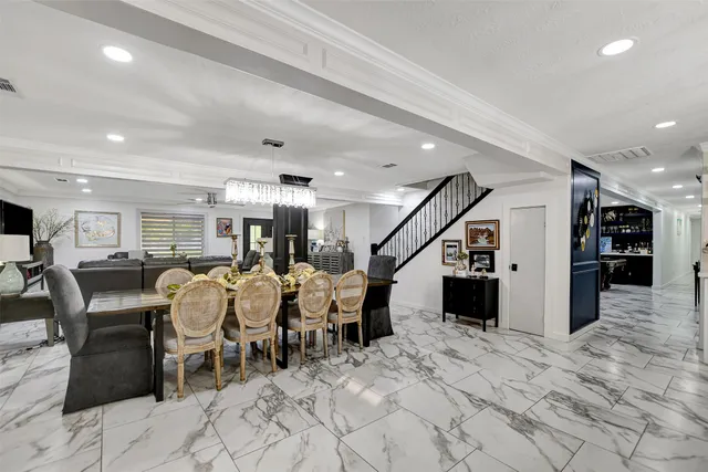 a view of a dining area with furniture and a chandelier