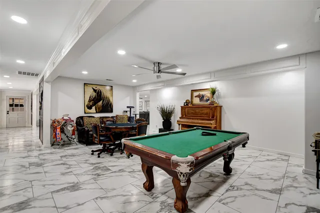a living room with furniture a rug and a chandelier