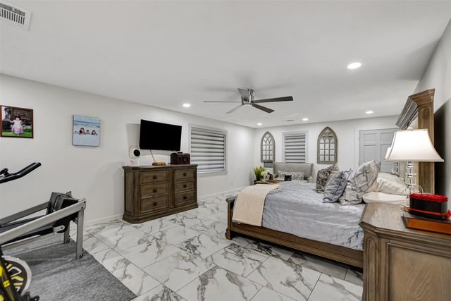 a bedroom with furniture and a flat screen tv