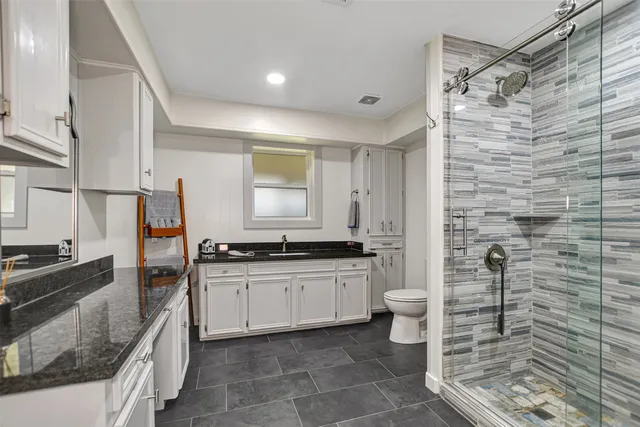 a bedroom with a bed and a flat tv screen on a dresser