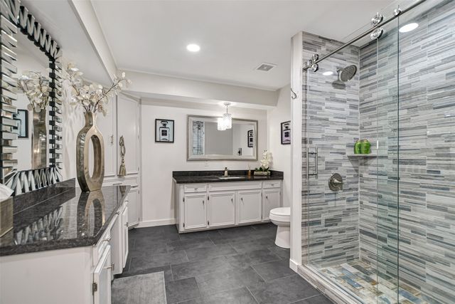 a living room with furniture a rug and a clock