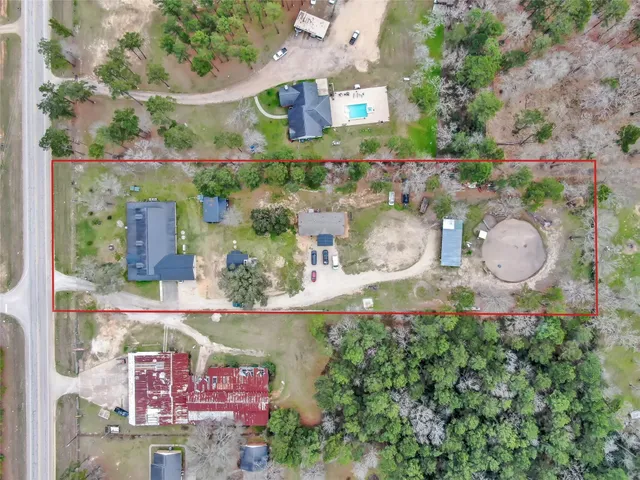 an aerial view of a house with a yard