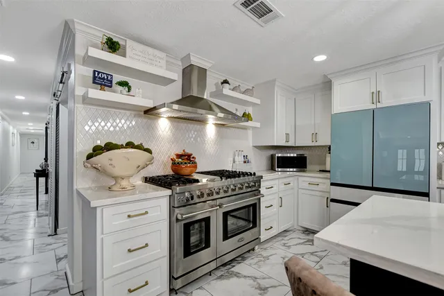 a kitchen with stainless steel appliances a stove a sink and cabinets