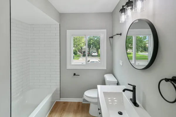 a bathroom with a toilet a sink and a window