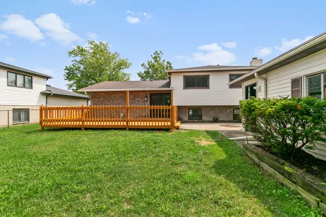 a view of a house with a yard and sitting area