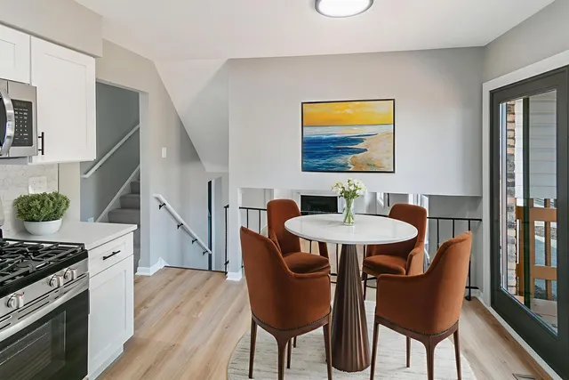 a dining room with furniture a chandelier and wooden floor