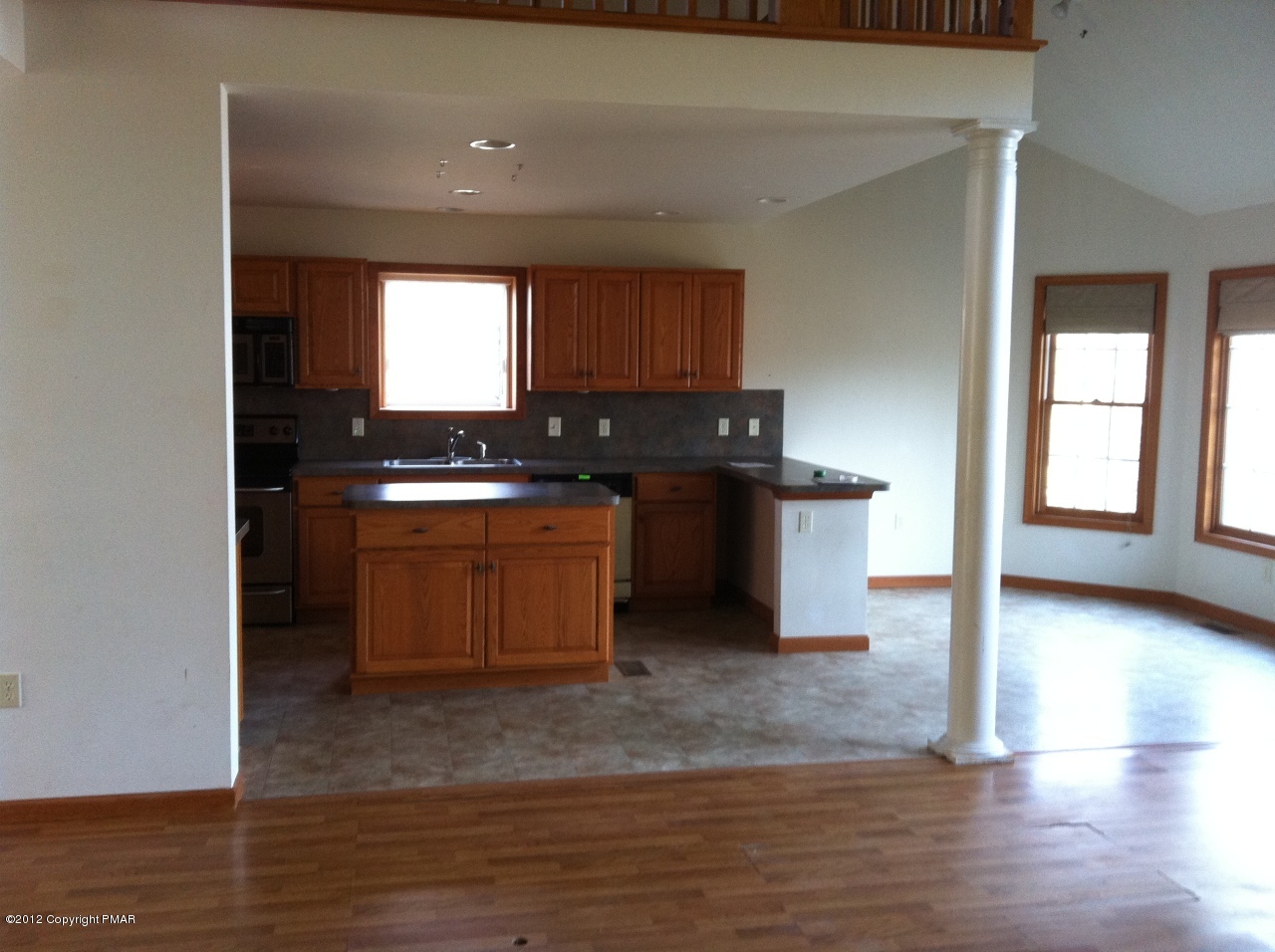 141 Rodeo Drive Hawley, PA 18428 - Photo 5 of 17 a kitchen with stainless steel appliances granite countertop a stove a sink and a refrigerator