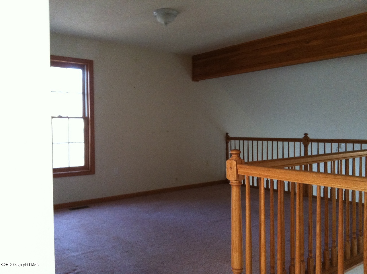 141 Rodeo Drive Hawley, PA 18428 - Photo 10 of 17 a view of a hallway with wooden floor and stairs