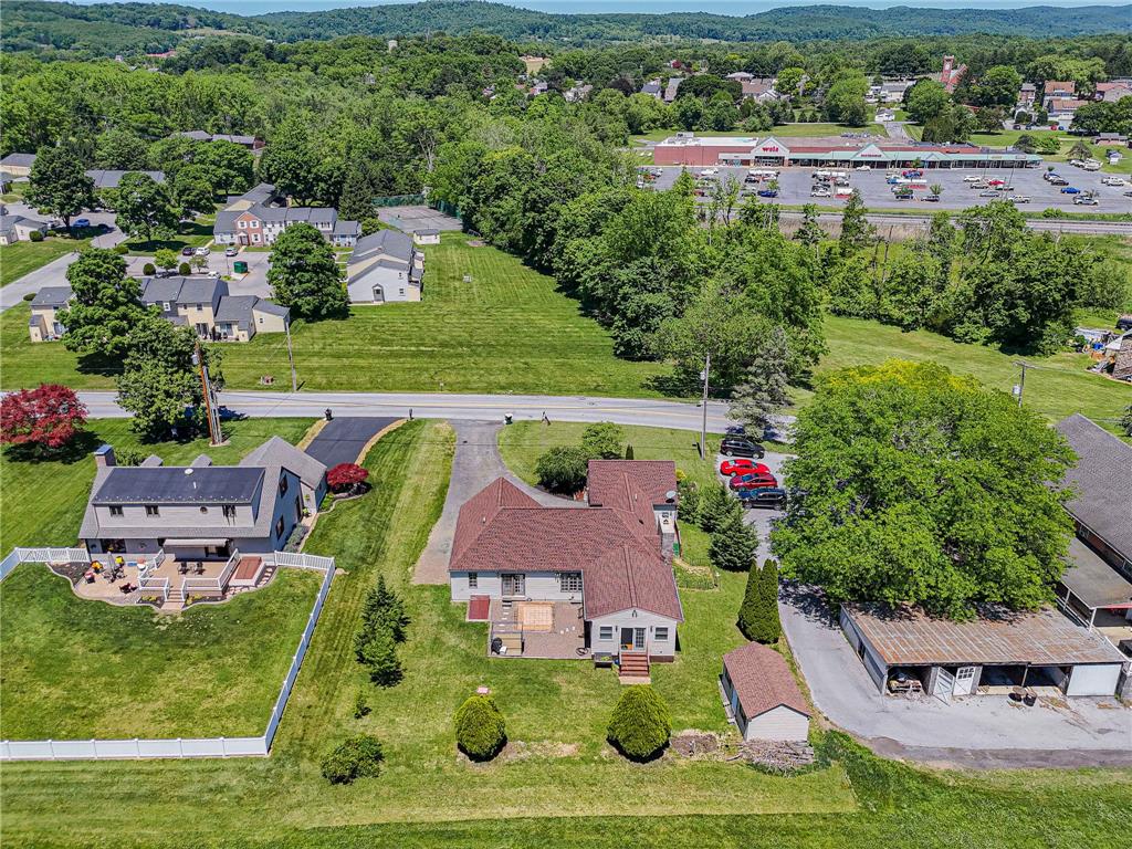 652 Old State Road Oley, PA 19547 - Photo 49 of 54 An aerial perspective reveals a charming residential setting nestled amidst verdant landscapes, showcasing multiple homes and outbuildings.