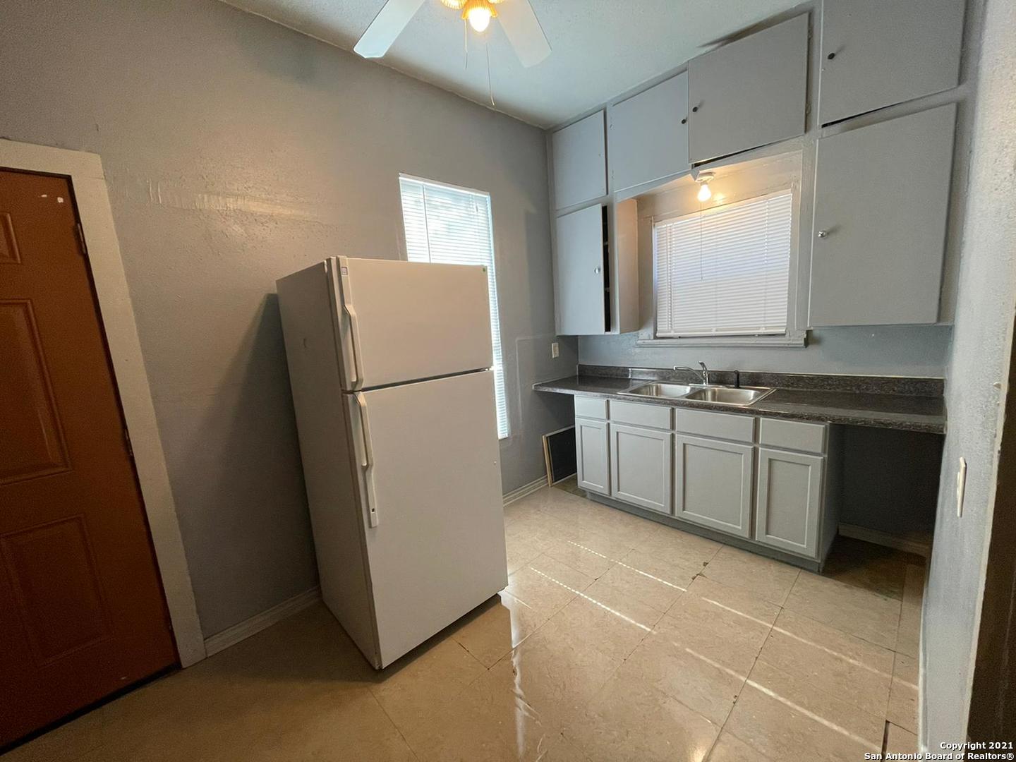 730 Carolina Street, Unit 1 San Antonio, TX 78210 - Photo 5 of 9 a kitchen with a stove a refrigerator and a sink