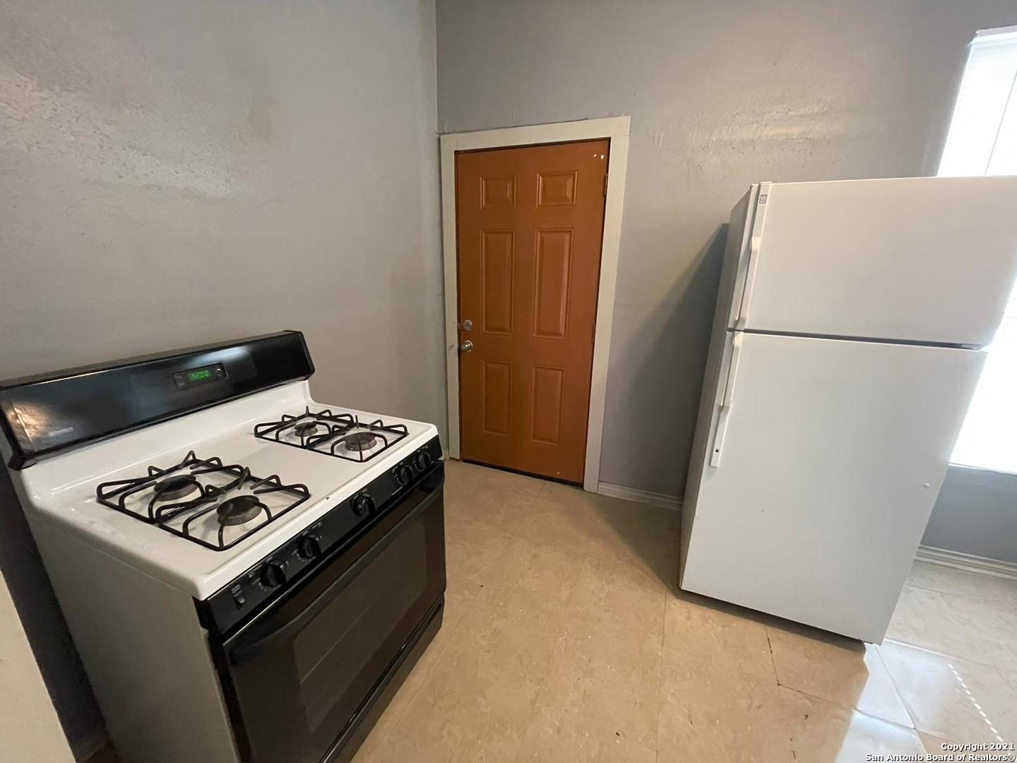 730 Carolina Street, Unit 1 San Antonio, TX 78210 - Photo 6 of 9 a kitchen with a stove and a refrigerator