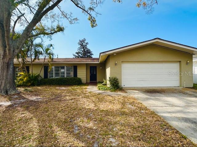 1046 Chinaberry Road Clearwater, FL 33764 - Photo 1 of 1 a front view of a house with a garden