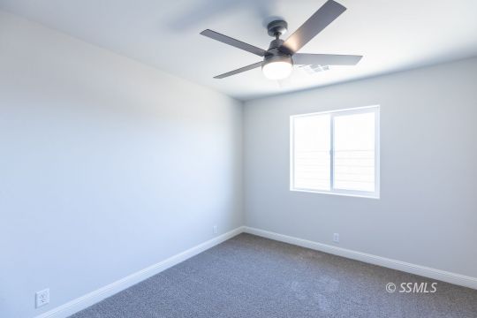 1012 Sims Street Ridgecrest, CA 93555 - Photo 22 of 36 an empty room with a window and a fan