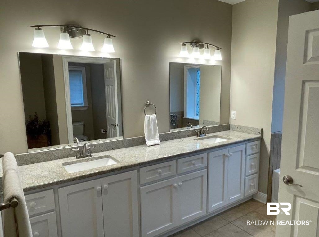 6426 East Quarry Drive Elberta, AL 36530 - Photo 9 of 19 Bathroom featuring dual vanity, tile patterned flooring, and toilet