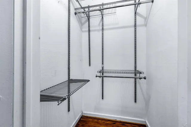 a bathroom with a granite countertop sink a toilet a mirror and shower