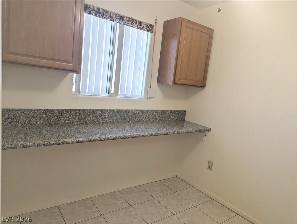 9433 Quail Ridge Drive Las Vegas, NV 89134 - Photo 16 of 23 Functional utility space with ample counter and cabinet storage.