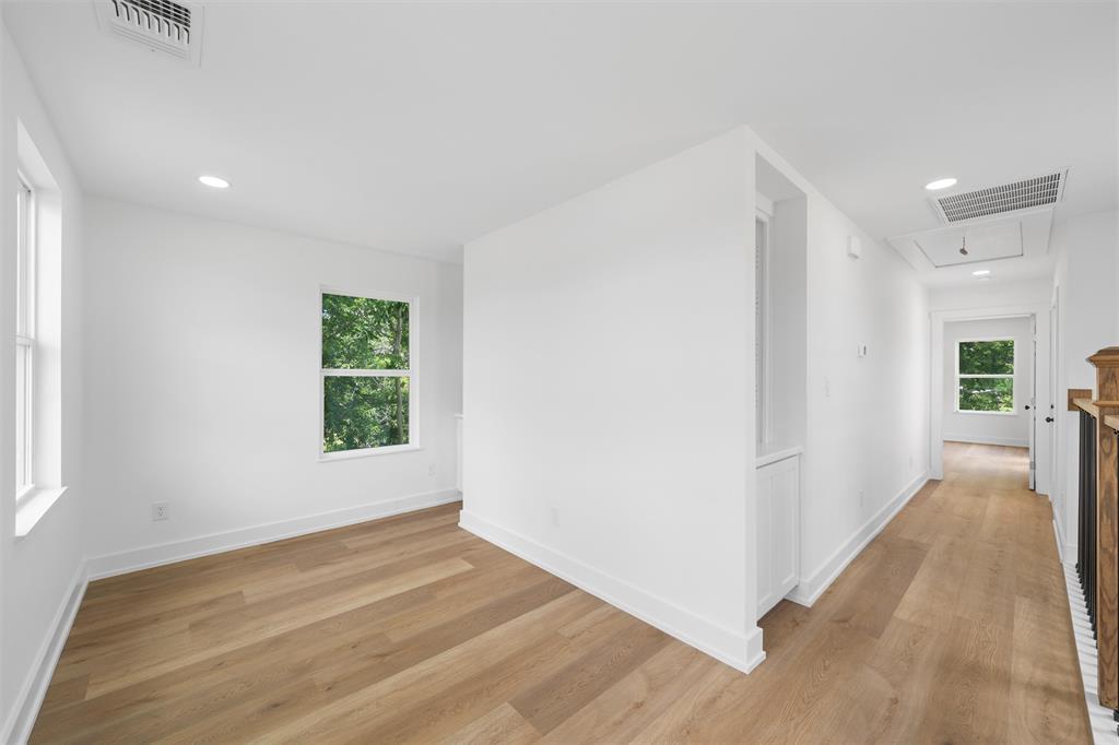 721 Taylor Street Waco, TX 76704 - Photo 13 of 28 an empty room with wooden floor and windows