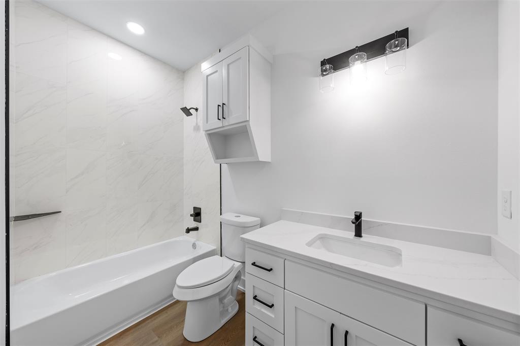 721 Taylor Street Waco, TX 76704 - Photo 22 of 28 a bathroom with a sink a toilet and shower
