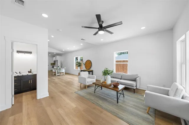 a living room with furniture and a view of kitchen