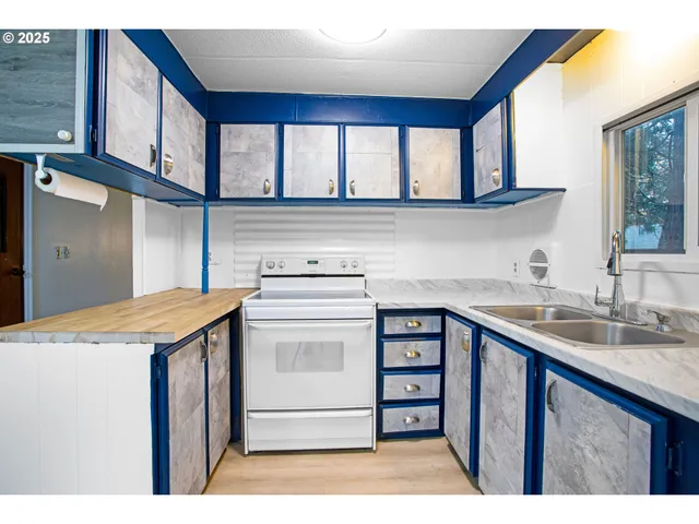 a kitchen with a sink a stove and cabinets