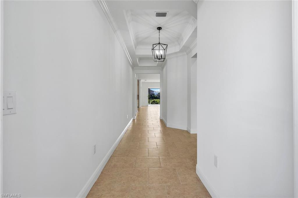 3529 Pilot Circle Naples, FL 34120 - Photo 13 of 47 a view of a hallway with wooden floor