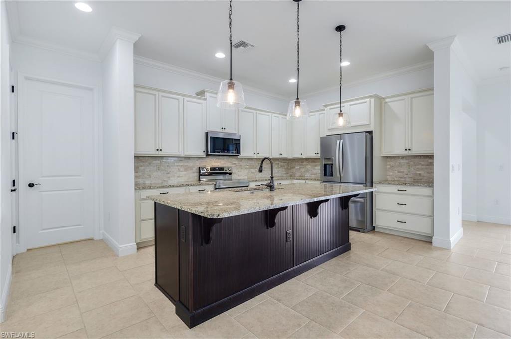 3529 Pilot Circle Naples, FL 34120 - Photo 20 of 47 a large kitchen with cabinets and stainless steel appliances