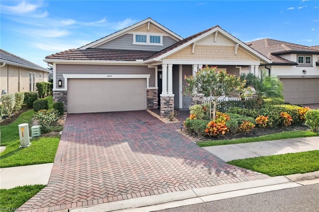 3529 Pilot Circle Naples, FL 34120 - Photo 2 of 47 a front view of a house with a yard and potted plants