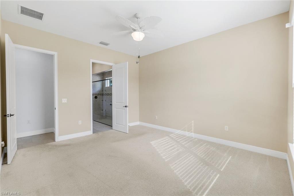 3529 Pilot Circle Naples, FL 34120 - Photo 22 of 47 an empty room with a ceiling fan and a window
