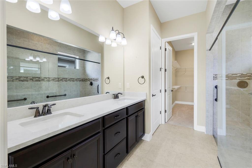 3529 Pilot Circle Naples, FL 34120 - Photo 24 of 47 a spacious bathroom with a double vanity sink mirror double and shower