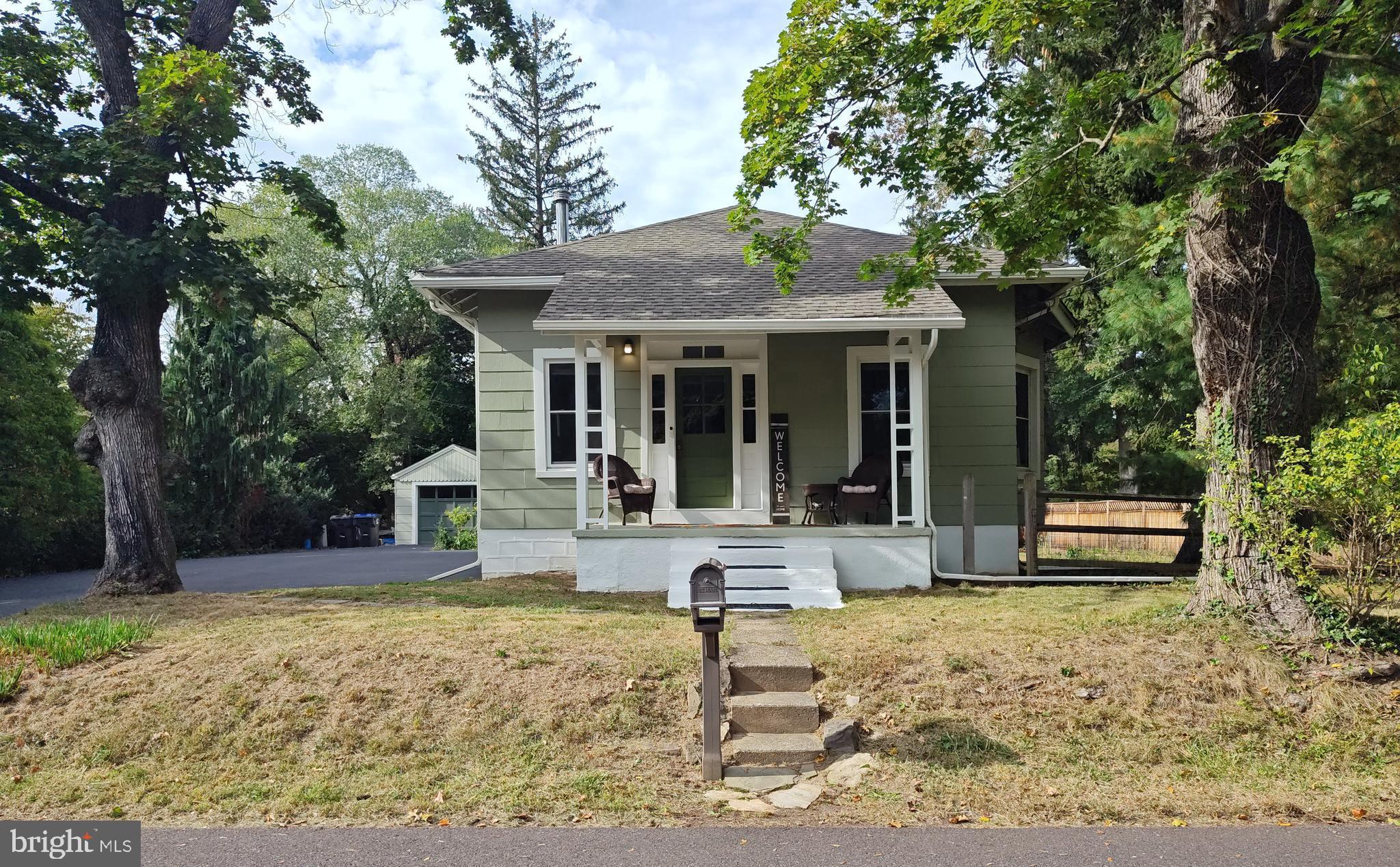 a view of a house with backyard porch and sitting area