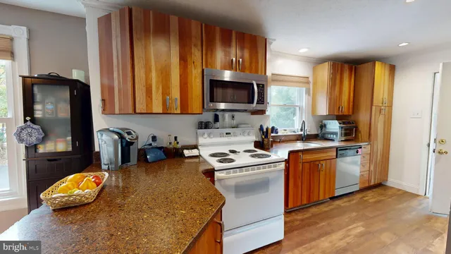 a kitchen with a sink stove and microwave