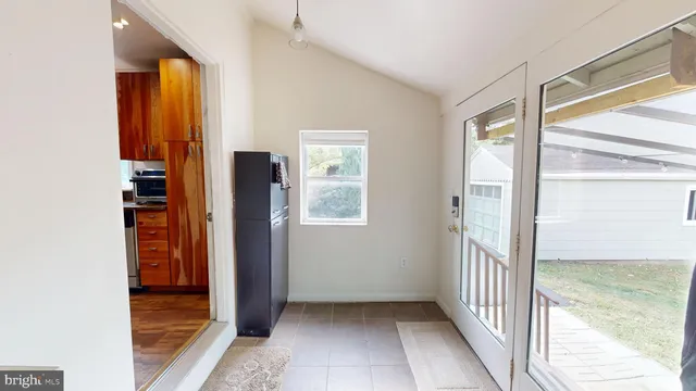 a view of entryway with a floor to ceiling window and wooden floor