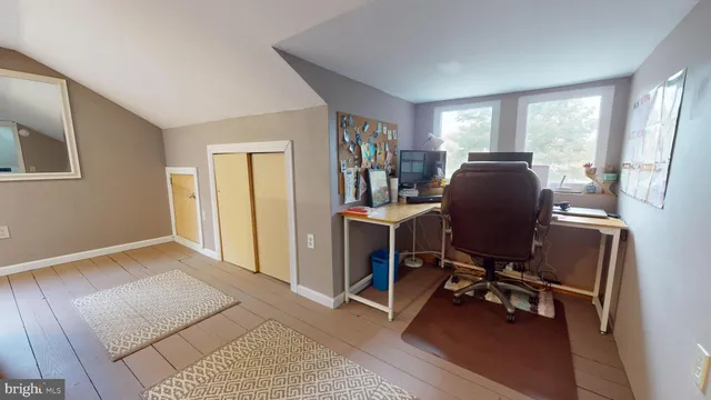 a view of a workspace with furniture and a window