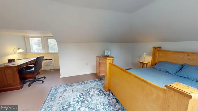 a bed room with a bed and a chair