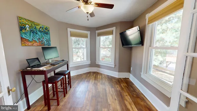 a view of a livingroom with furniture window and wooden floor
