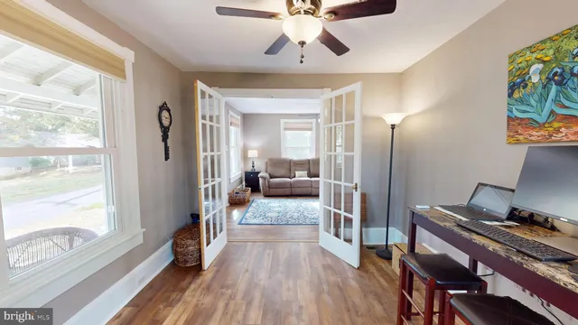 a view of a hallway with wooden floor and a window