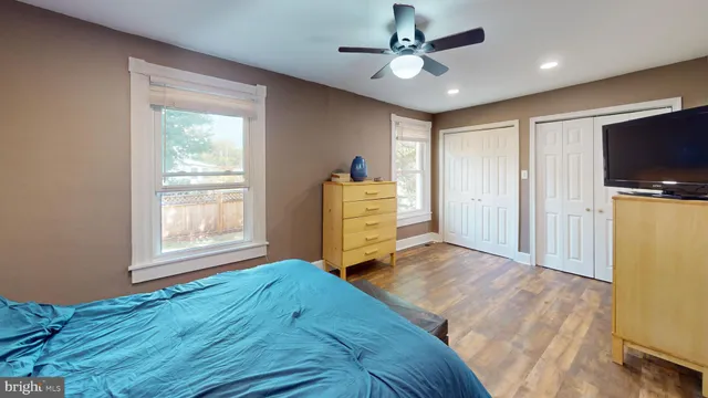 a bedroom with a bed dresser and a window