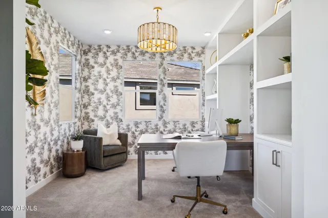 a workspace with furniture and a chandelier