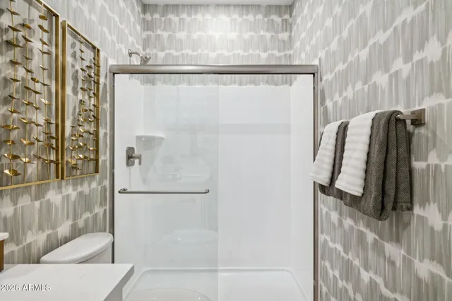 a bedroom with a bed and a wall painting